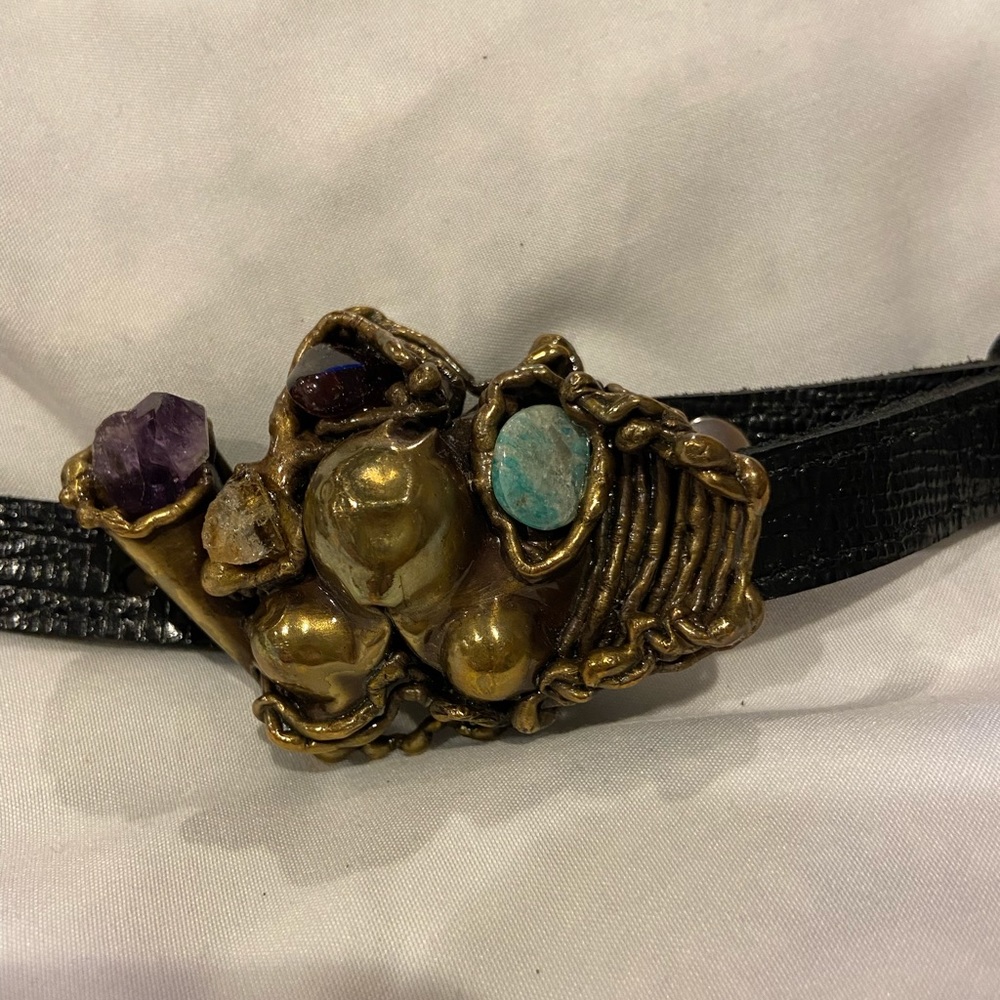 1/2” black belt with a beautiful stone and metal buckle.